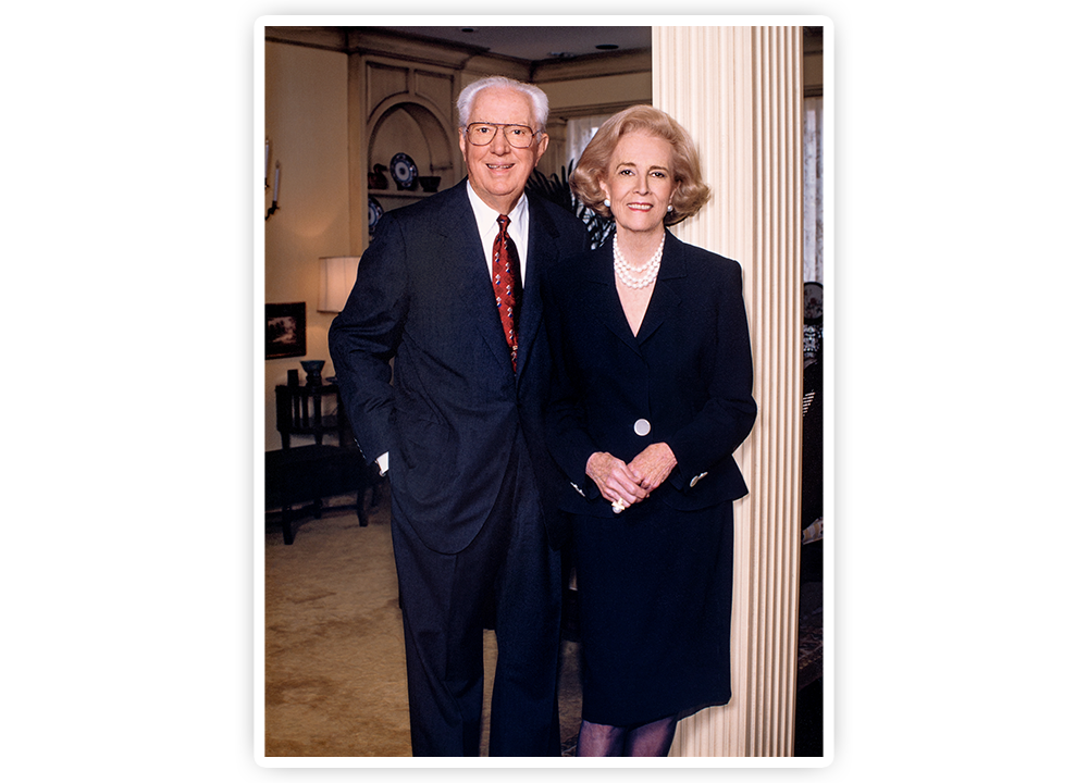 A photo of John S. Justin, Jr. and Jane Justin posting near a pillar.